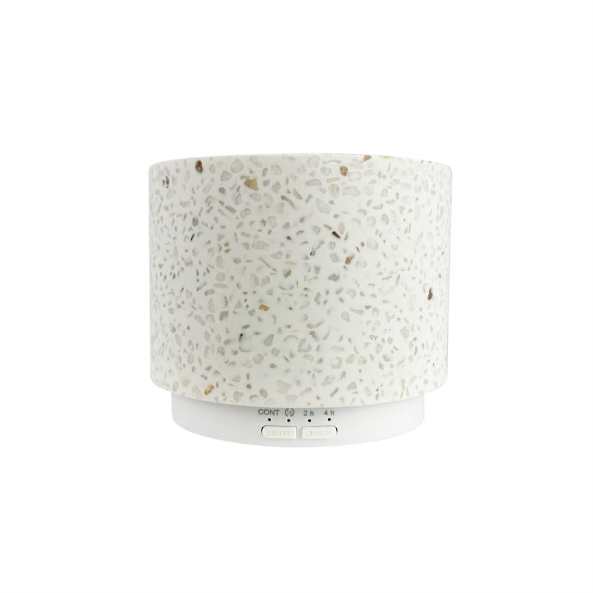 Cylindrical terrazzo fragrance diffuser — stands without visible vapor — against a clean, white background. Text on the base: "CONT 2 h 4 h" and the buttons "LIGHT" and "MIST".