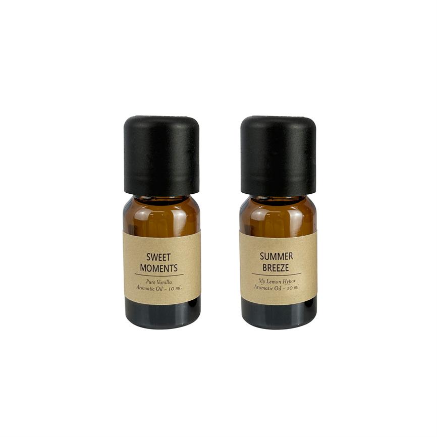 Two small amber aroma bottles with black lids stand side by side on a white background.
 
 Text on labels:
 - SWEET MOMENTS / Pure Vanilla / Aromatic Oil - 10 ml
 - SUMMER BREEZE / My Lemon Hypot / Aromatic Oil - 10 ml