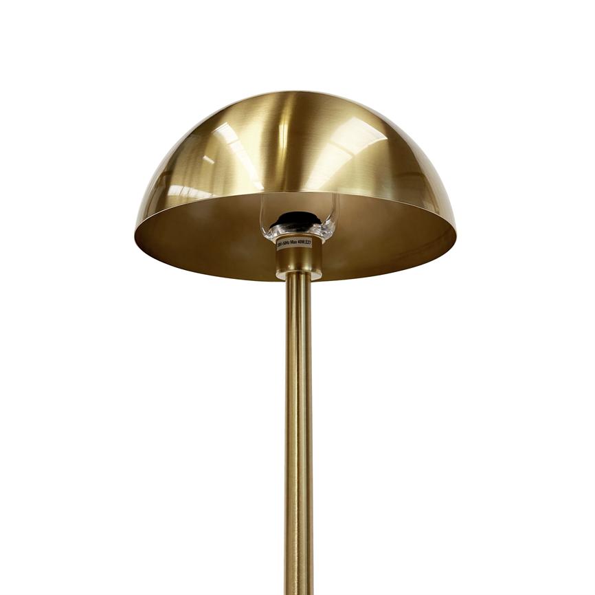 Brass floor lamp with hemispherical shade, shade reveals bulb socket; mounted on slender brass rod in front of white background. A small label under the plinth is illegible.