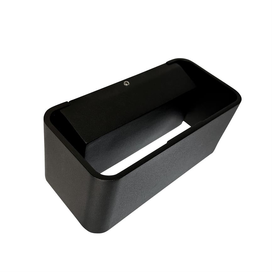 Black rectangular wall fixture shows an elongated front opening and a visible mounting screw, designed for directional up or down lighting in a modern interior.