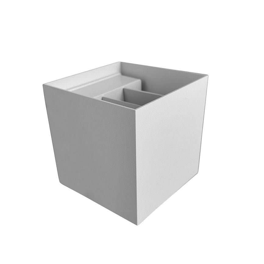 A square storage box in white/grey, contains separate compartments for pens and small items; stands alone against white background with soft shadow, simple modern aesthetic.