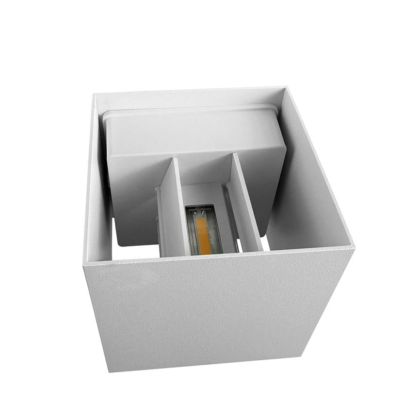 Cubic wall lamp contains a visible COB-LED module facing downwards between two internal shields in a white, minimalist, open square housing.