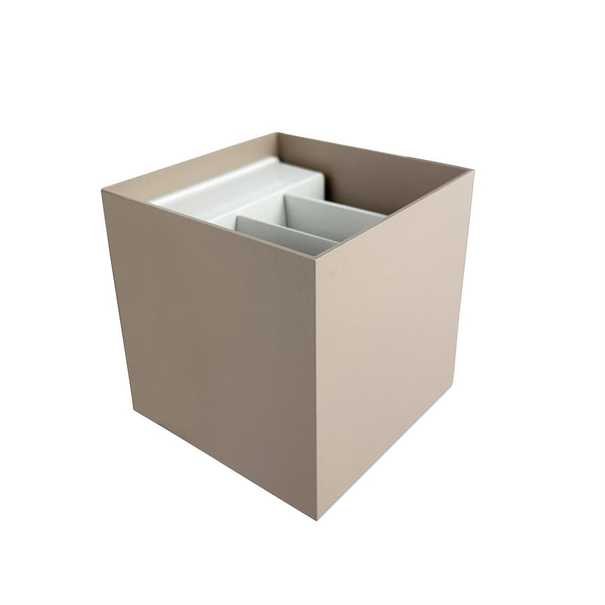 Beige square storage box with open top; inside three white partitions form separate rooms. Placed on neutral white background.