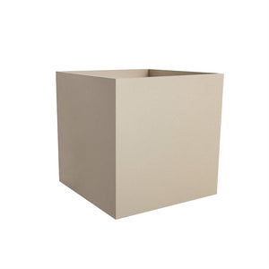 A beige, cubic planter stands open and empty on a white, uniform background; soft shadows suggest light from the right, minimal and isolated presentation.