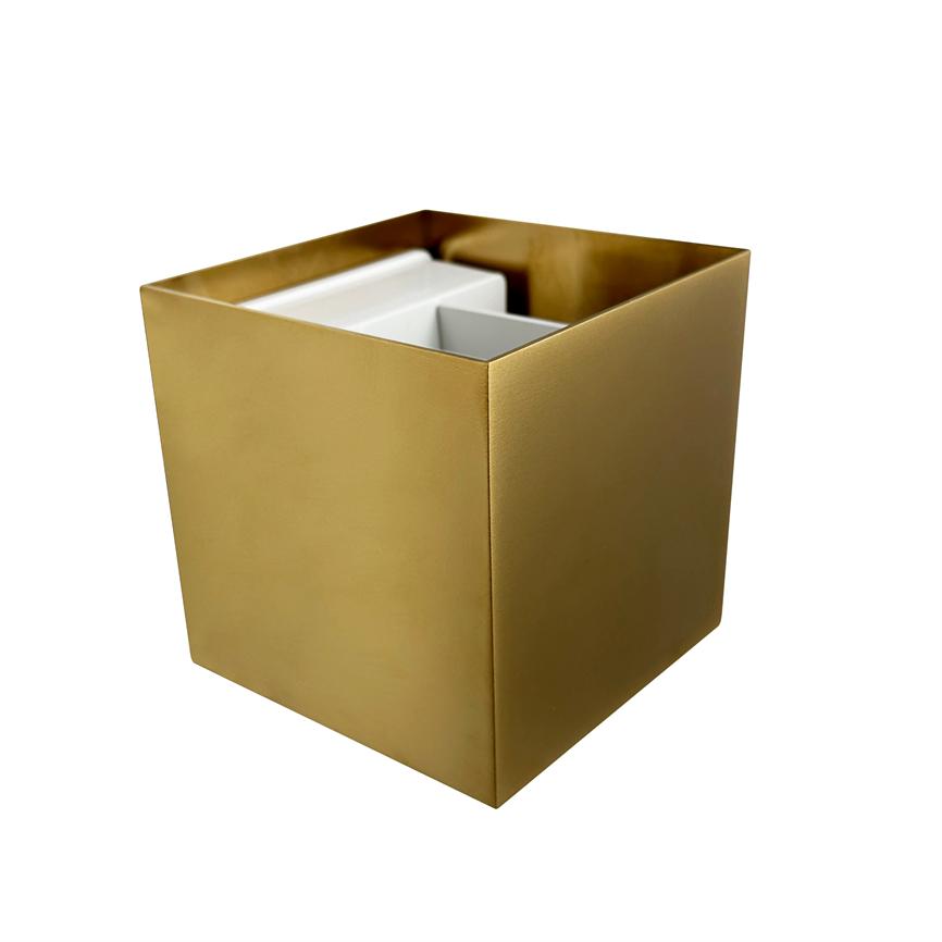 A gold colored cubic container stands open and contains white inserts/partitions, placed on a uniform white background.