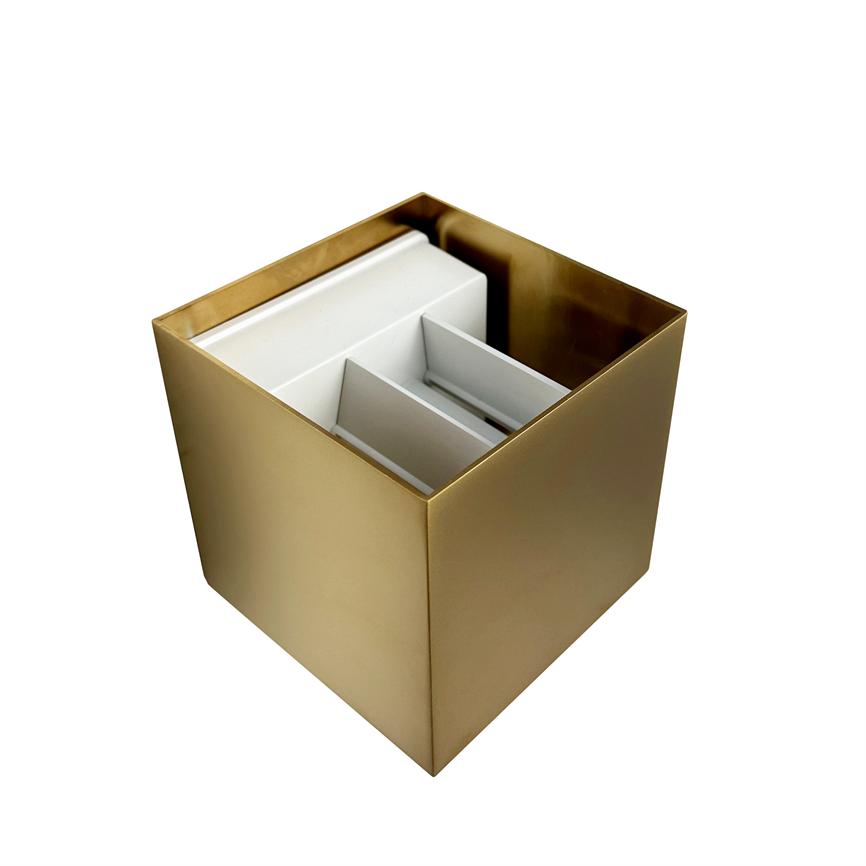 Gold-colored, square container houses white interior spaces and vertical partitions; the object stands alone on a uniform, clear white background with no other elements.