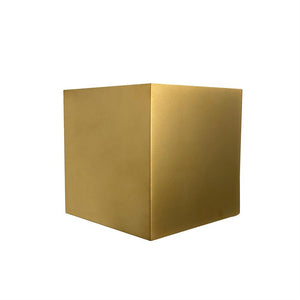 Gold cube stands centered on white background; two faces and one corner are visible, with soft light reflections on its matte, golden surface.