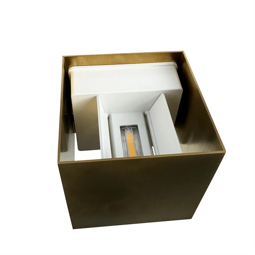 A square copper colored metal box (lamp) contains a white inner frame with a visible LED module; designed to hide and direct light, isolated on white background.