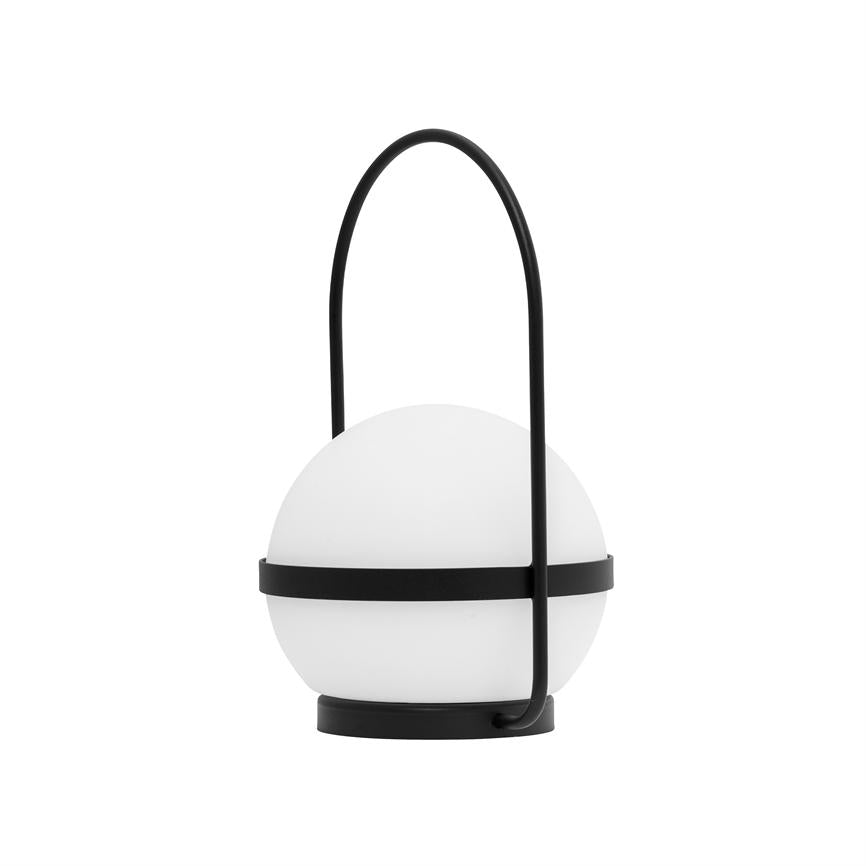 Table lamp with white spherical shade, framed by black metal bands and curved black handle bracket; it rests on a small round black foot against a white background.