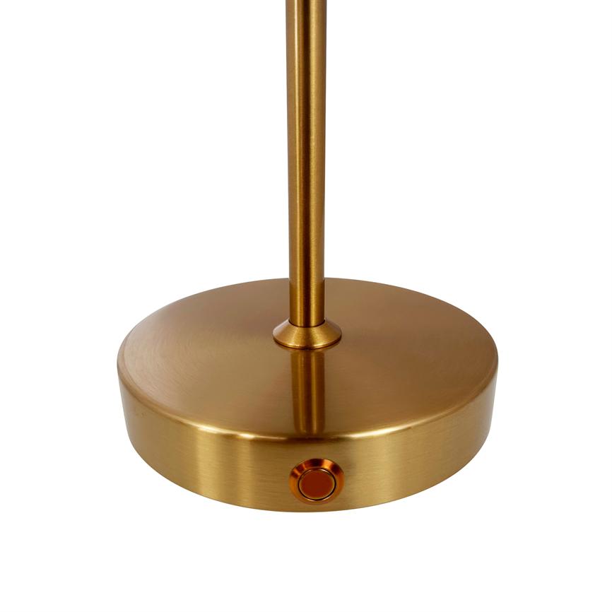 The metal base of the lamp stands upright with a slender rod attached in the middle; a round press button sits on the side. The object is golden, placed on a white background.