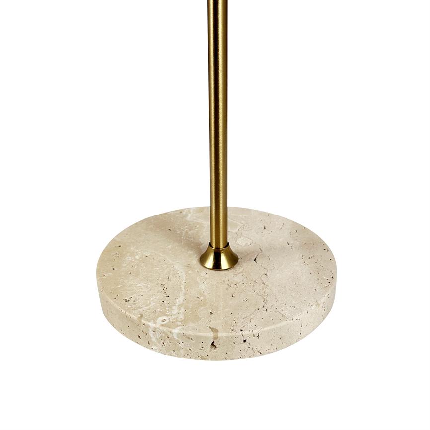 A round beige stone base supports a slender gold-colored metal rod; the element stands centered and isolated against a uniform white background, with visible stone pores and polished surface.