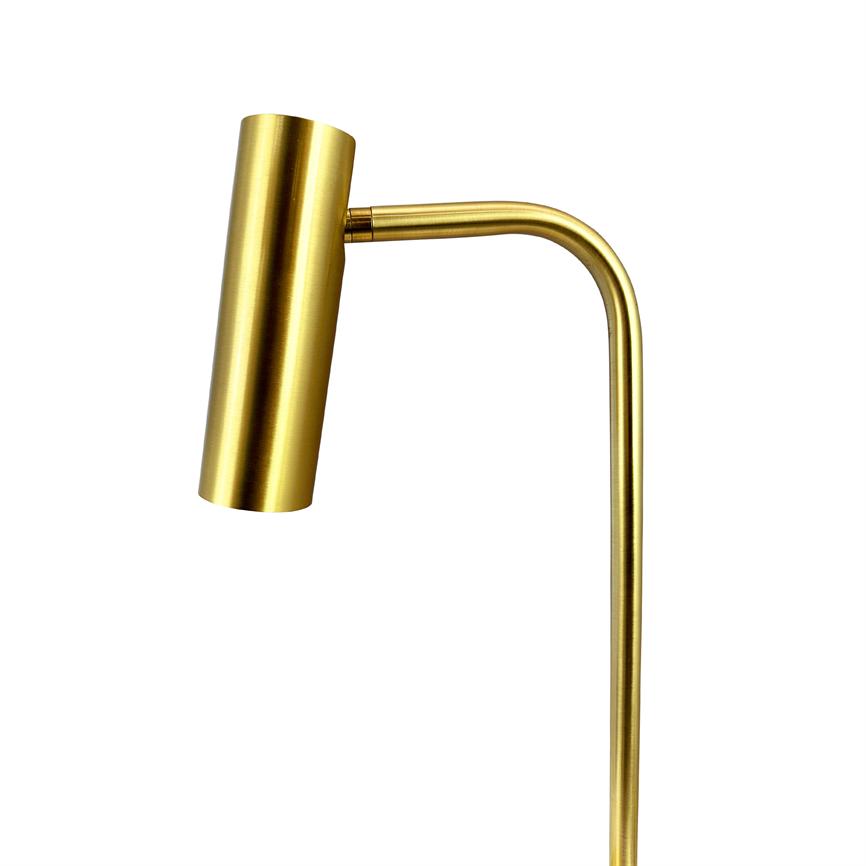 Gold-coloured, cylindrical reading lamp with curved arm, pointing obliquely downwards; polished metal surface against neutral white background.