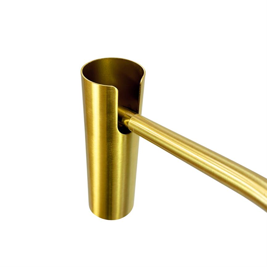 A brass-colored cylindrical holder (object) with a U-shaped cutout, into which a slender, curved brass rod is inserted and attached (action); neutral white background (context).