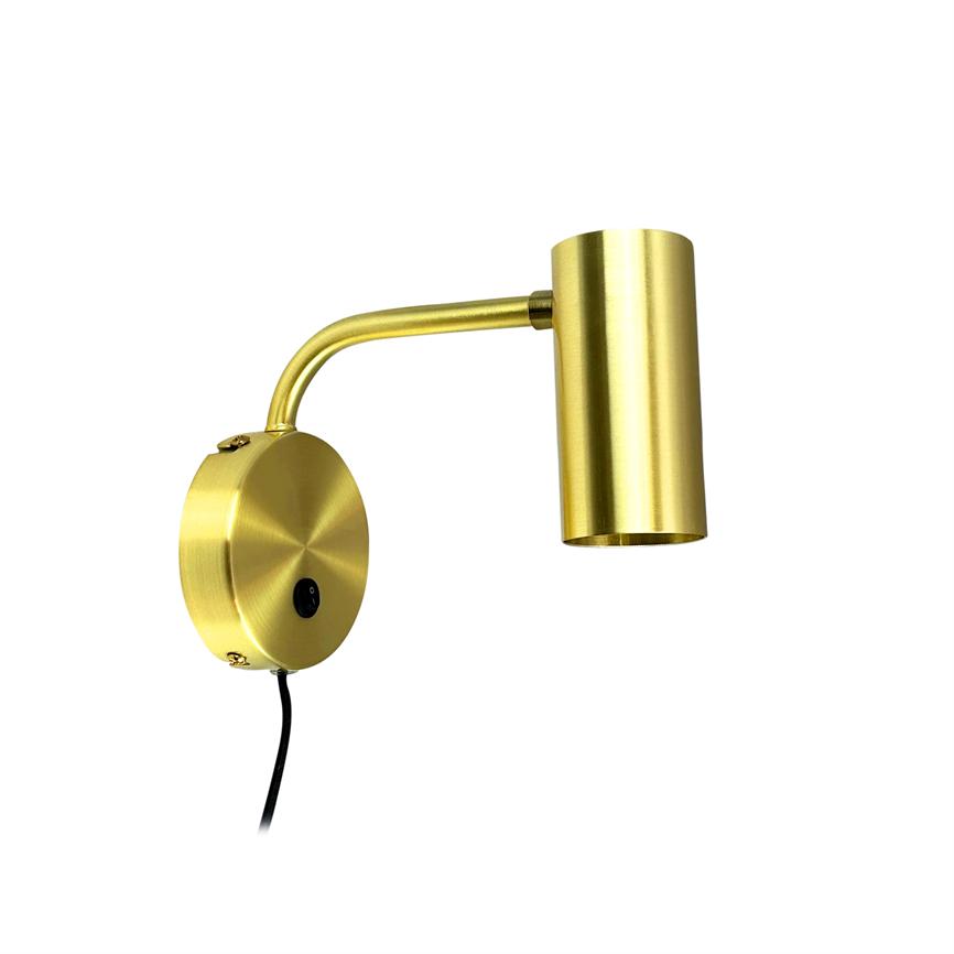 Gold-colored wall lamp with round wall base and curved arm; cylindrical screen points downwards. Black on/off button and wire visible. Stands alone against a uniform white background.