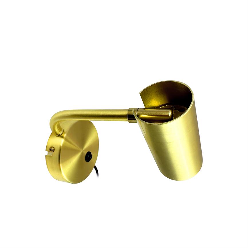 Gold colored wall lamp mounted on round base, arm extending and holding an angled cylindrical shade; spotlight points down on white, blank background.