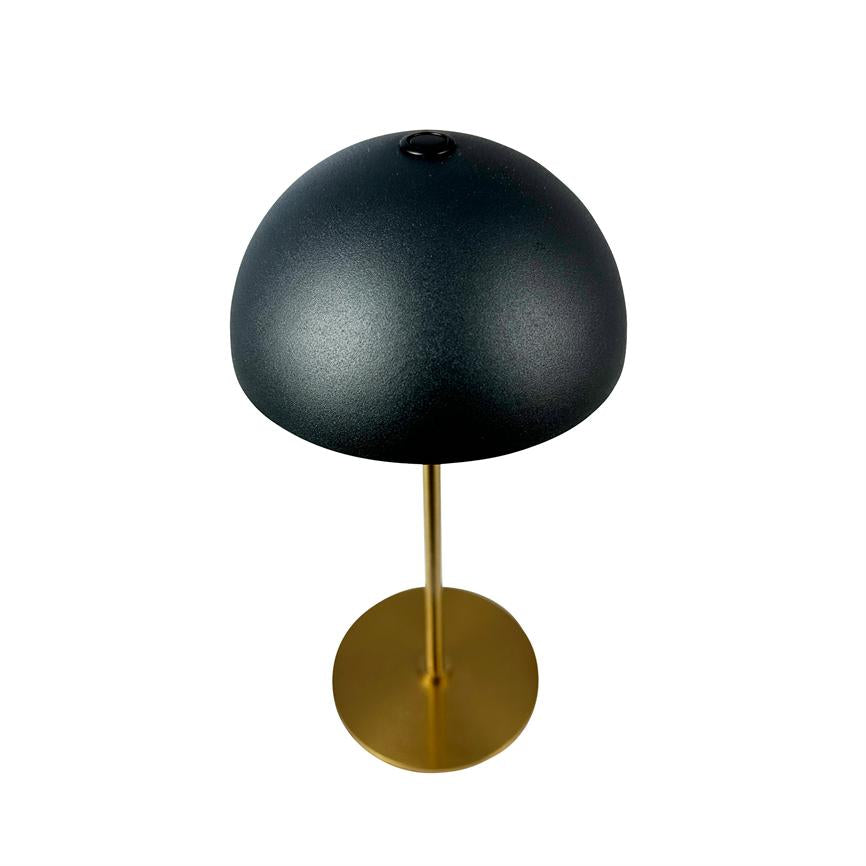 Table lamp with black hemispherical shade, mounted on a slender gold-coloured metal rod and round brass base, set against a uniform white background.