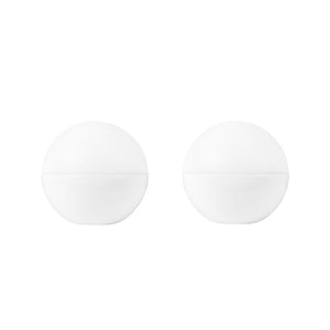 Two white, round containers stand side by side on a uniform white background; each has discreet horizontal stitching and a minimalist, symmetrical look.