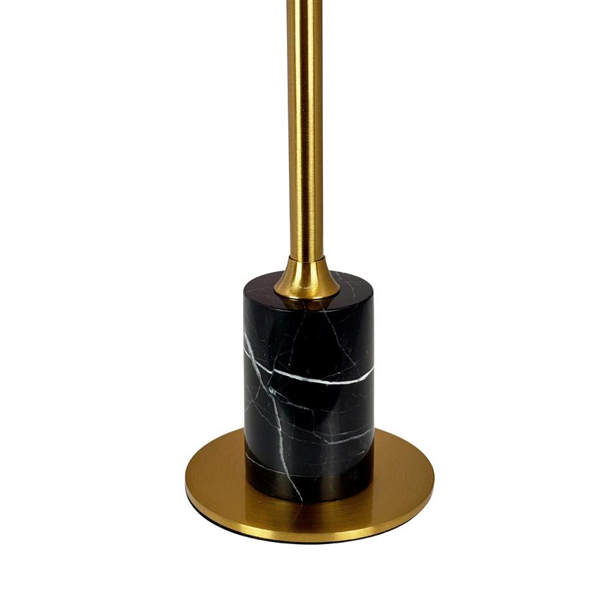 A golden rod is mounted in a black marble column, which rests on a round golden metal base in front of a uniform white background.