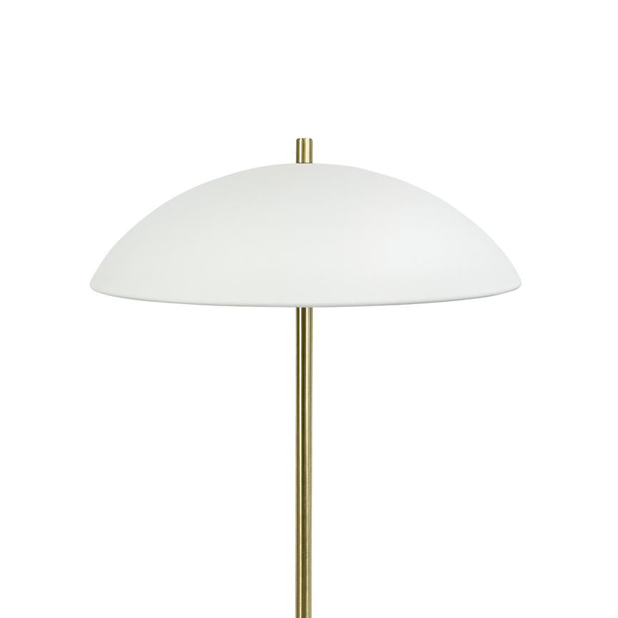 Lamp stands on a slender brass rod and carries a large white dome shade; simple, minimalist light source placed against a uniform white background.