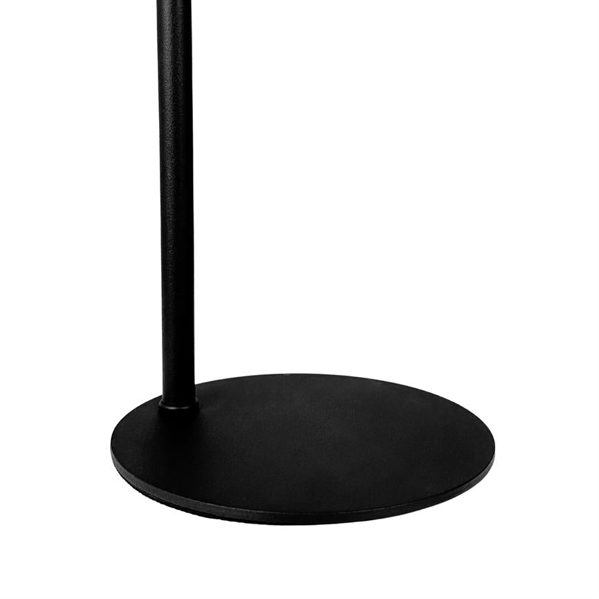 Black circular metal base supports a vertical pole; stands steady on a clean, white background in a minimalist studio setup.