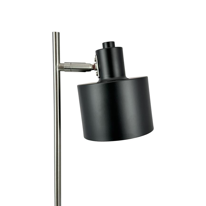 Floor lamp with black cylindrical shade; the screen is tilted forward and mounted on a slim, brushed silver metal rod, set against a pure white background.