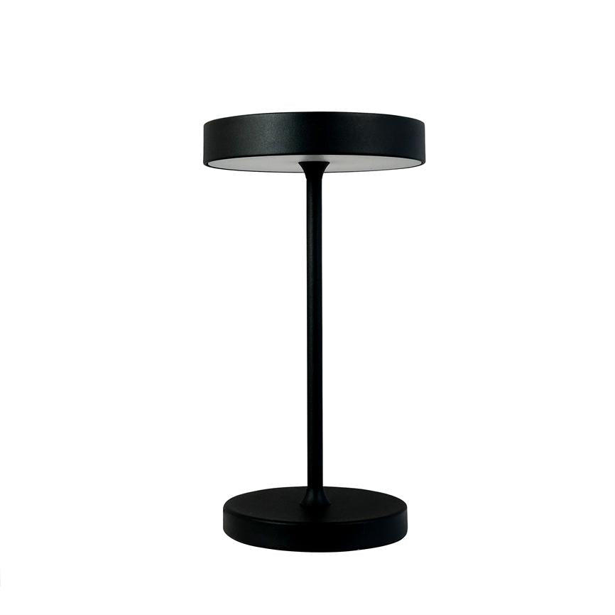 Black table lamp stands upright with a flat, round shade, thin central rod and circular foot in front of a uniform white background.