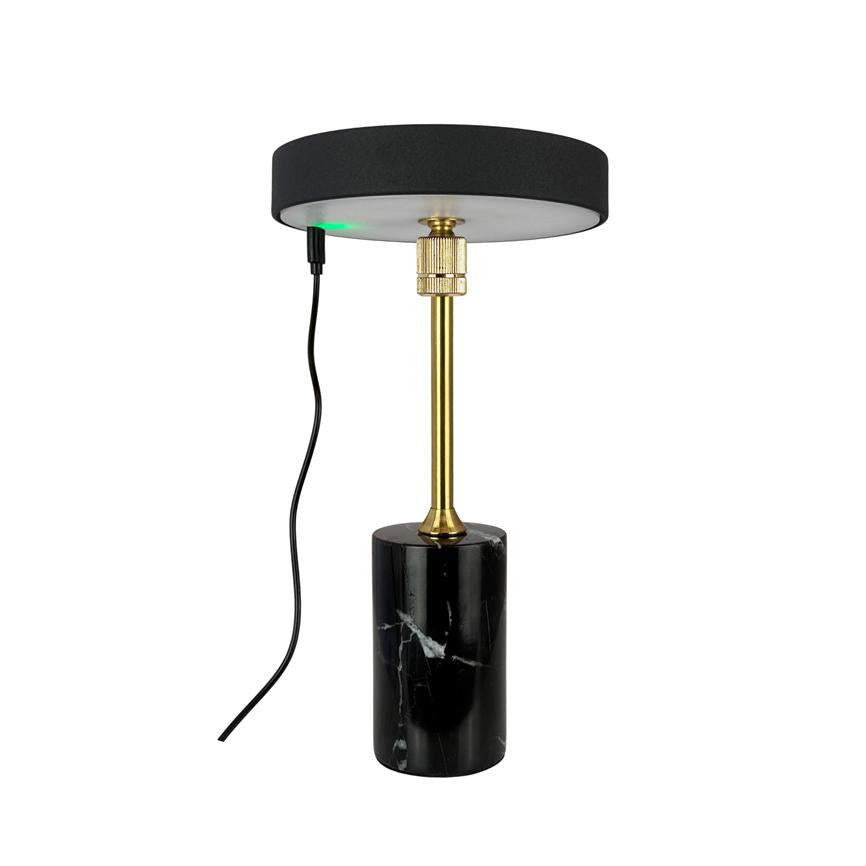 Black marble column lamp stands on a white background with a slim gold colored rod, round black shade and an outgoing black cable with a small green diode.