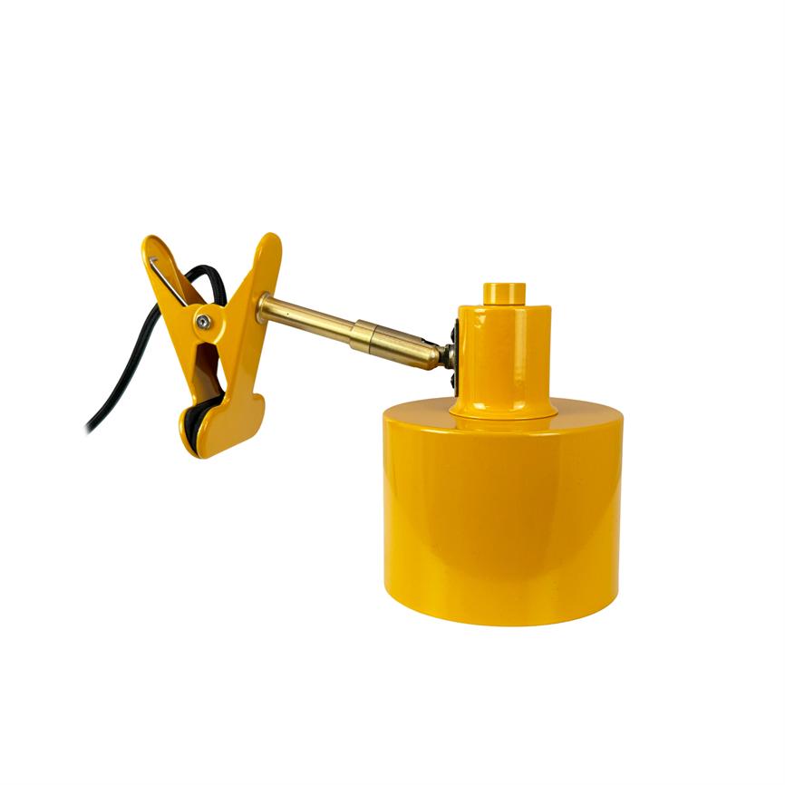 Clamp lamp with metal arm clamps via black cord and rubberized jaws, supports a cylindrical yellow lamp base; product photo on a uniform white background.