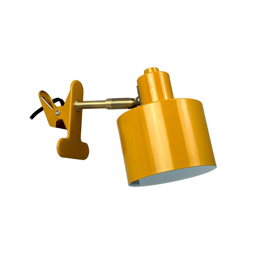 A yellow clip light clamps onto an adjustable metal arm and points downwards; the arm's articulated bracket and black cable are visible against a uniform white background.