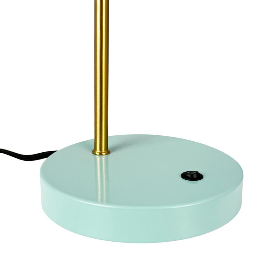 The lamp's round mint-green base supports a thin, vertical brass rod; a black on/off button sits on the foot and a black wire runs out to the left on a white background.