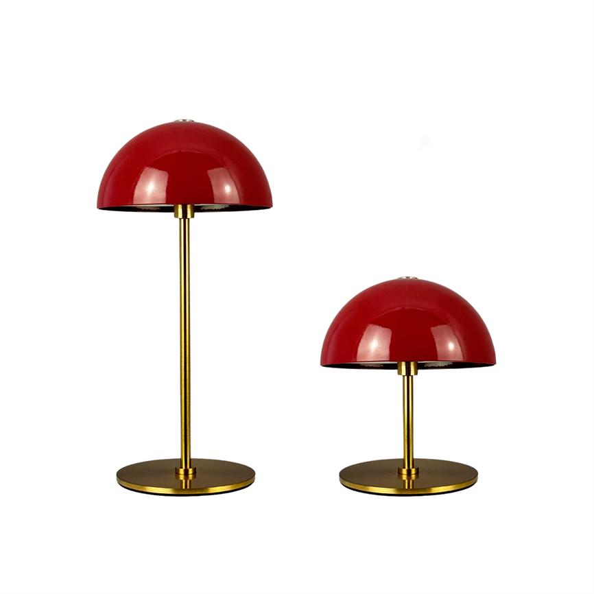 Two table lamps: red hemispherical shades on golden metal rods and round bases, one tall and one low, set against a pure white background.
