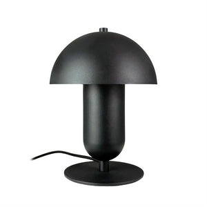 Sort bordlampe formet som en svamp står på en rund fod; kuppelskærm hviler over en cylindrisk krop, og et sort strømkabel ligger synligt mod en ren hvid baggrund.