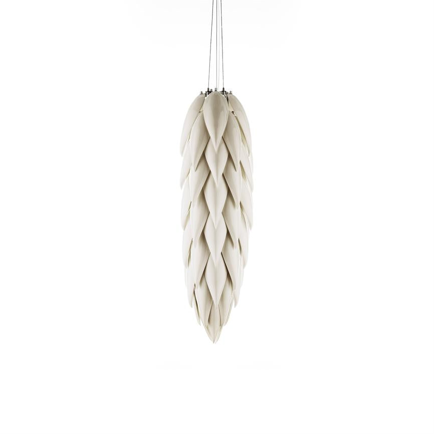 Pendant lamp with overlapping, leaf-like shades hangs quietly in thin black wires above a clean white background, giving an organic, modern look.